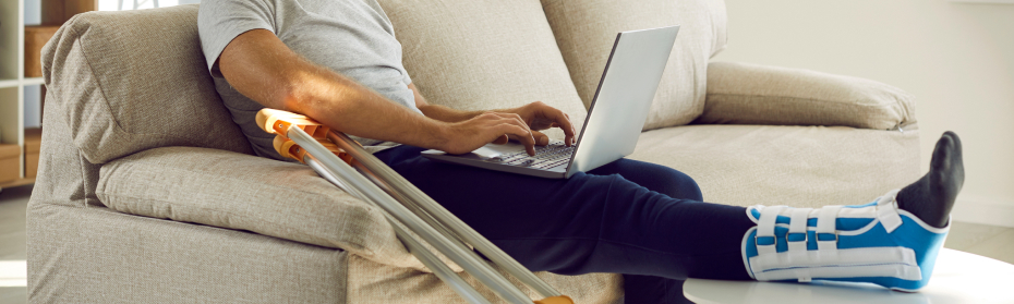 personal injury victim on couch using laptop